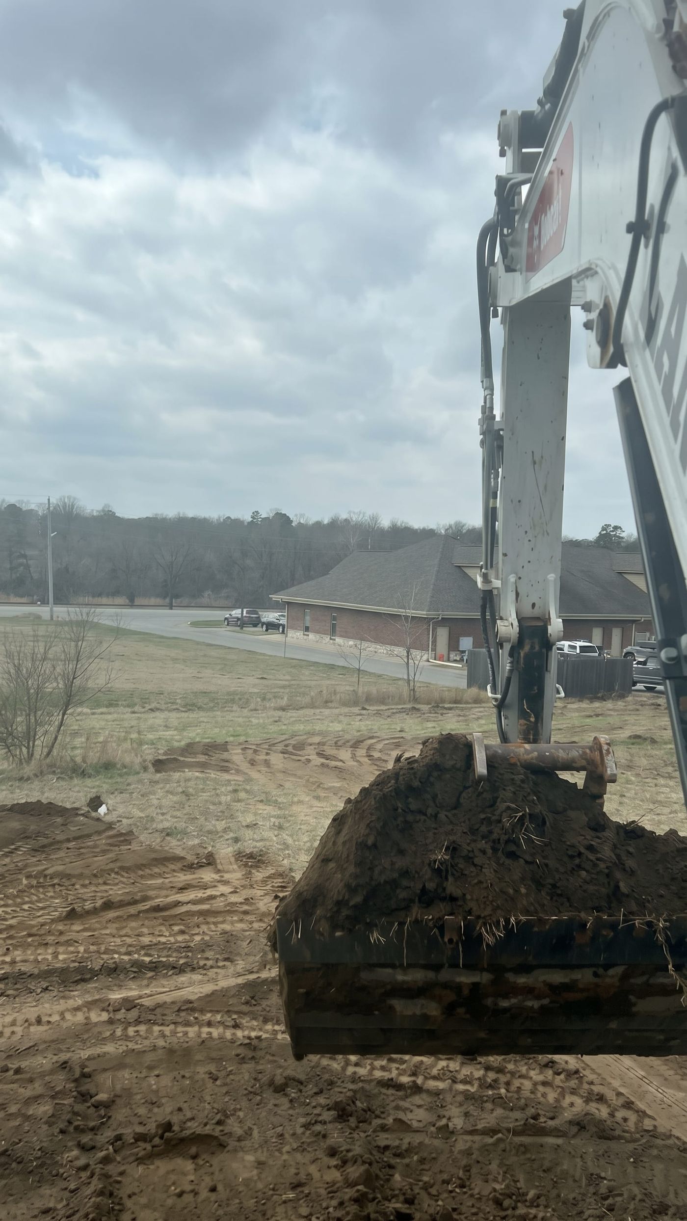 The excavator loading a red dump truck