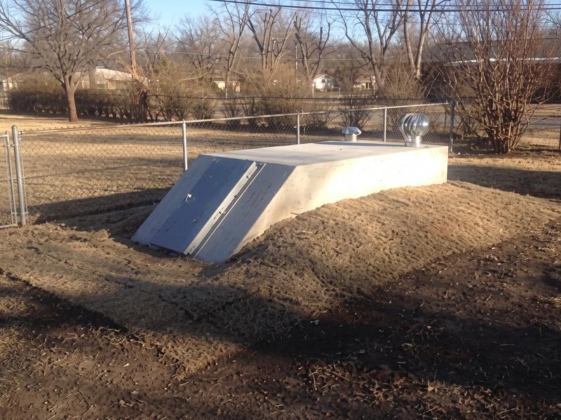 In-ground concrete storm shelter, freshly backfilled