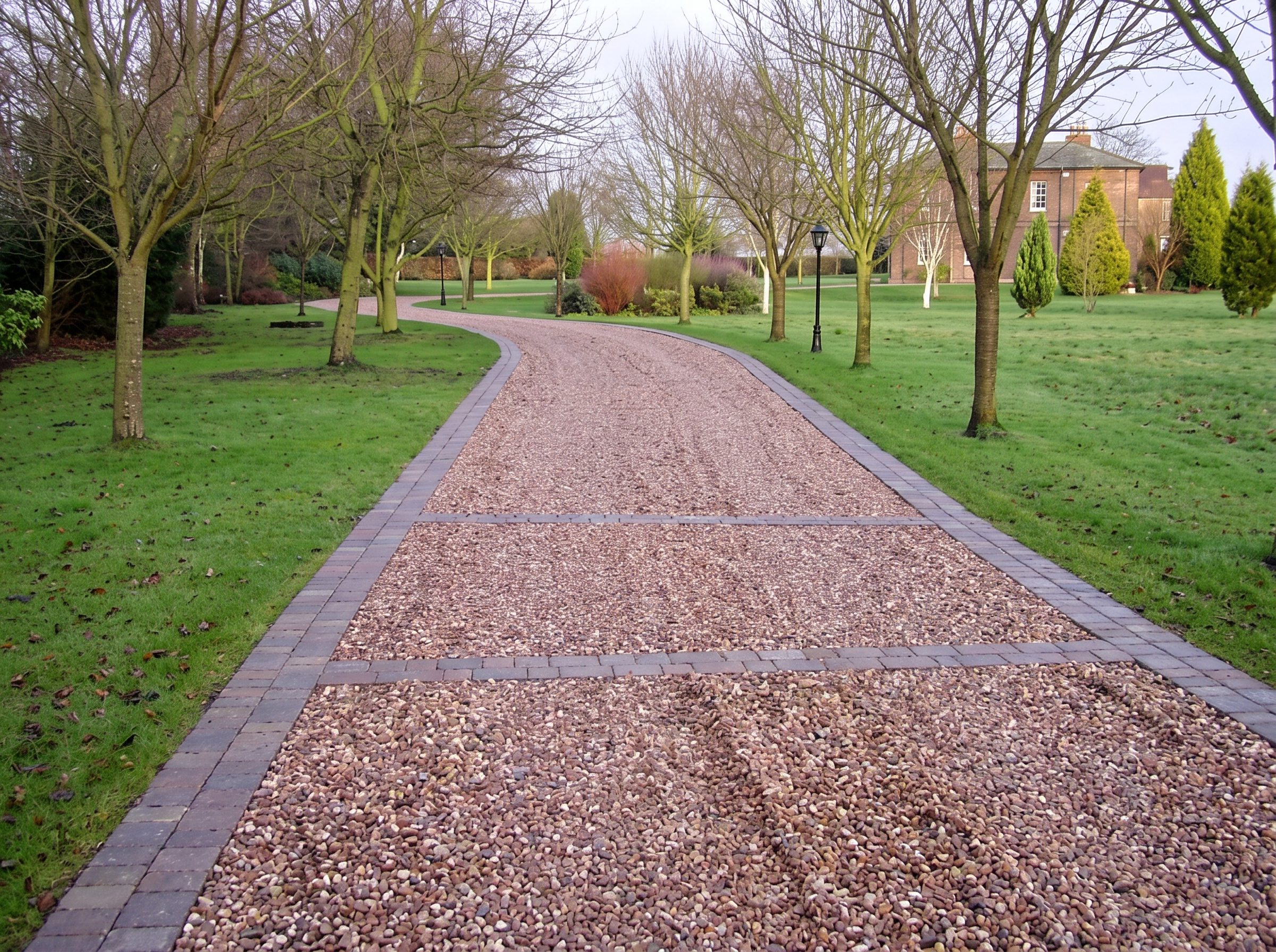 Edged path through a mown lawn and trees