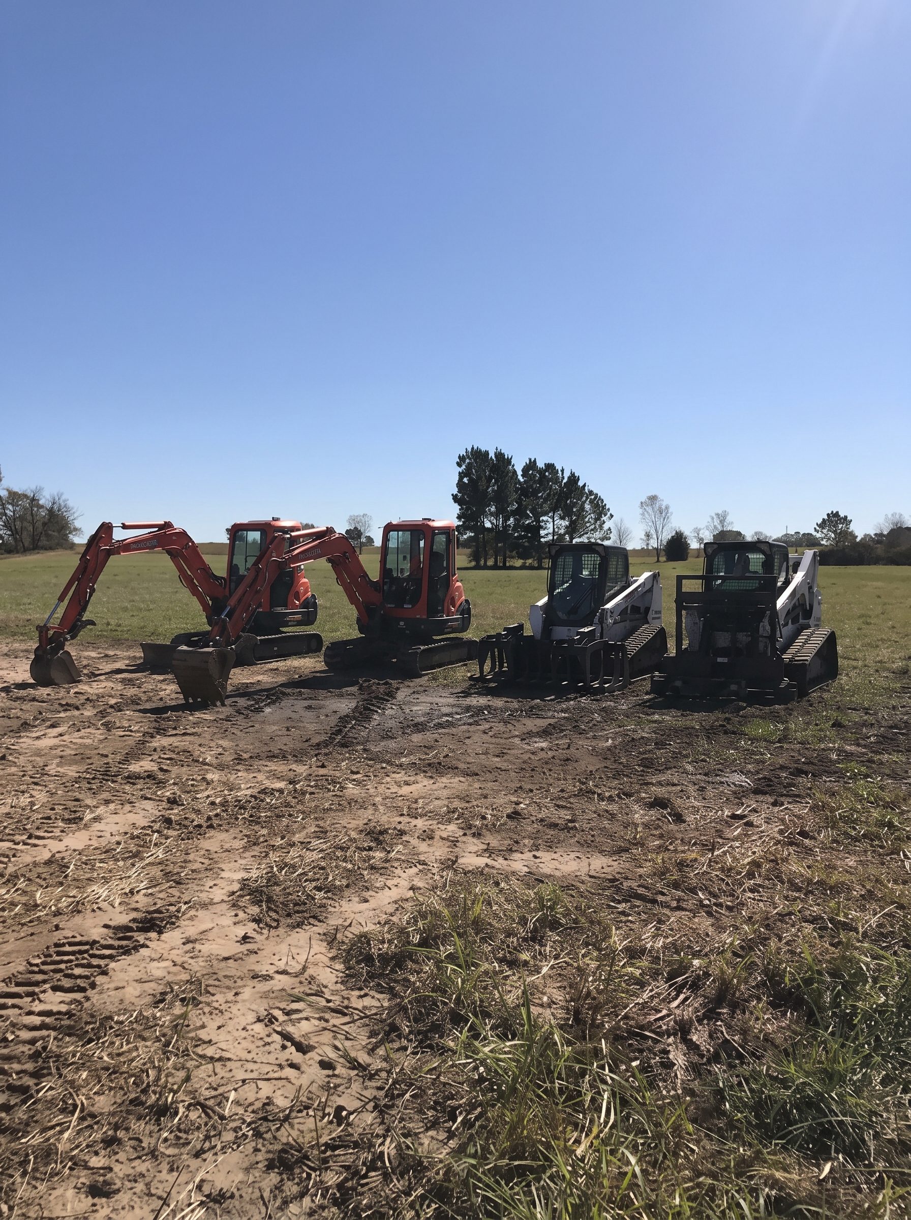 Equipment staged on a cleared field