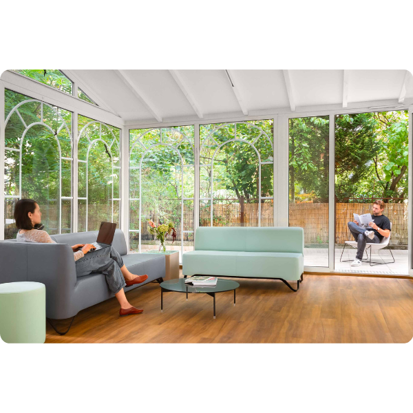 A man and woman sitting in the lobby of a Limehome