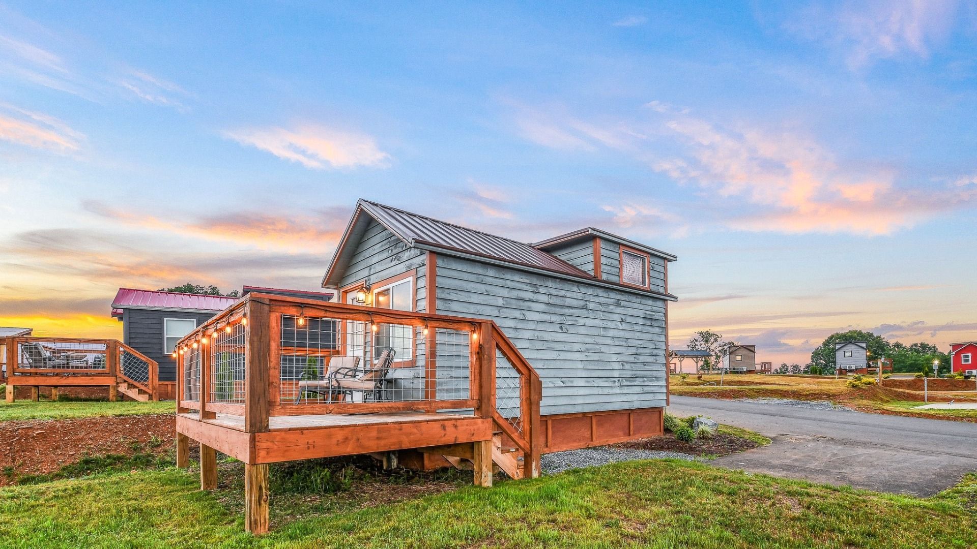 200 sq ft tiny home for two guests with a loft queen bed, kitchenette, bathroom, and forest views.