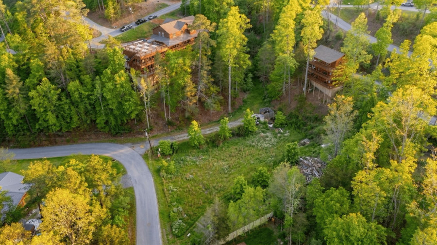 Drone photo of Elegant Elite Estate with mountain backdrop
