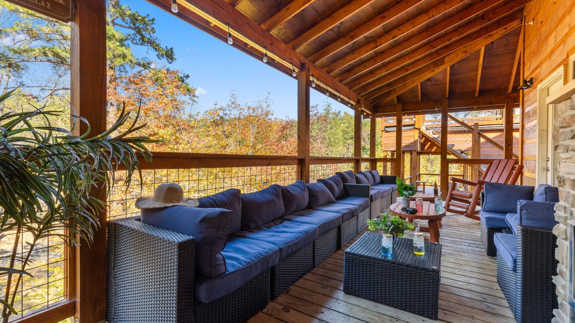 Covered deck with outdoor seating at Elegant Elite Estate