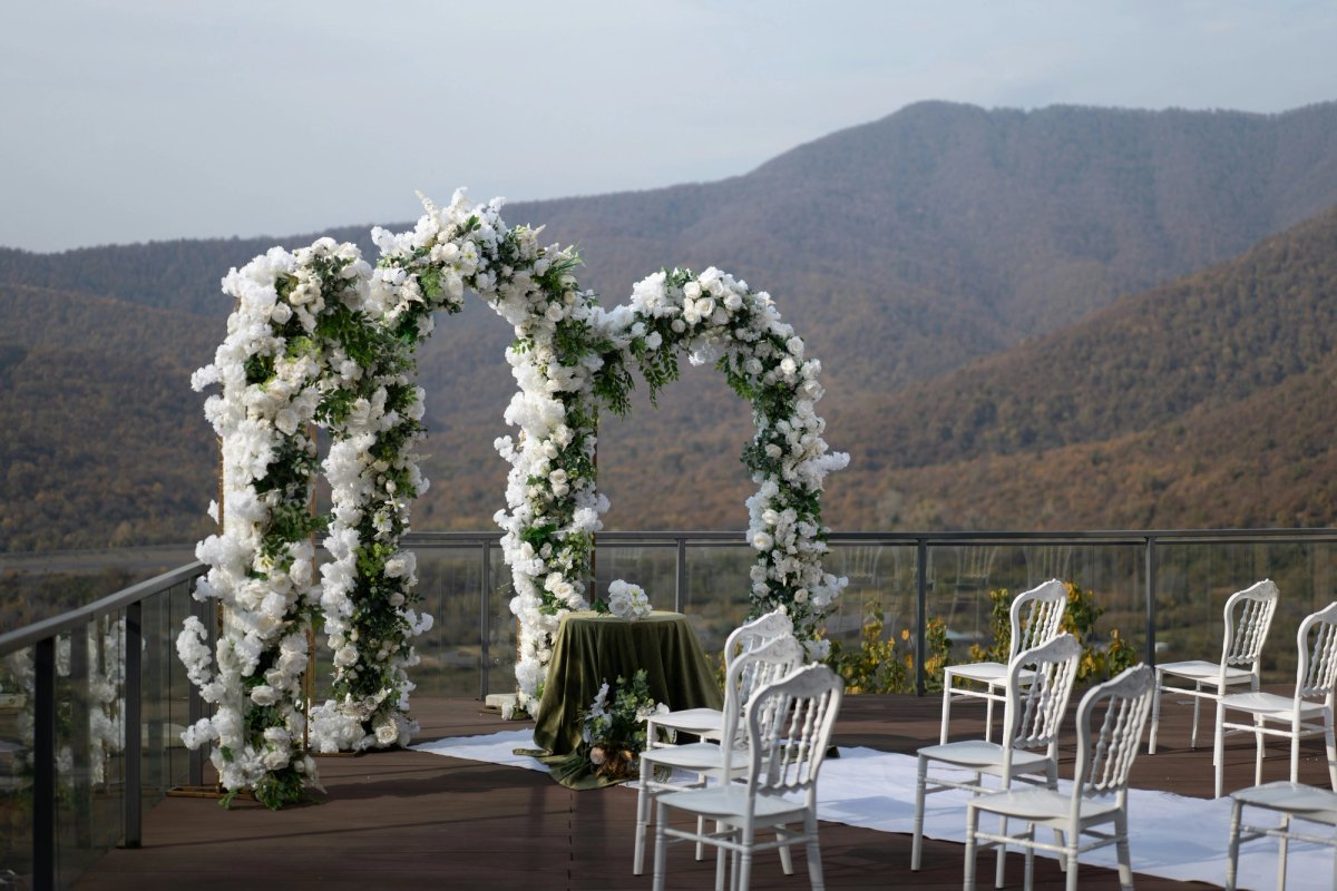 Wedding ceremony arches with chairs on a deck with mountain view