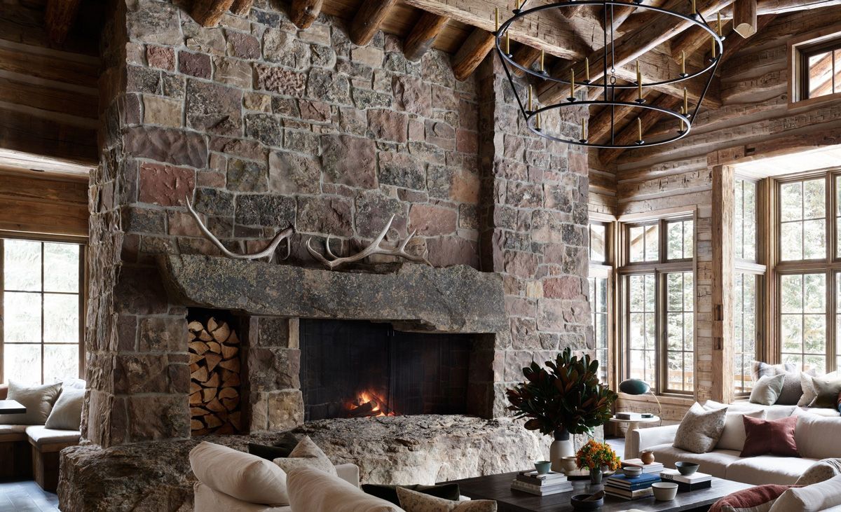 Stone fireplace and chimney in a log cabin living room (Idaho cabin, PRB Signature Series Montana Moss)