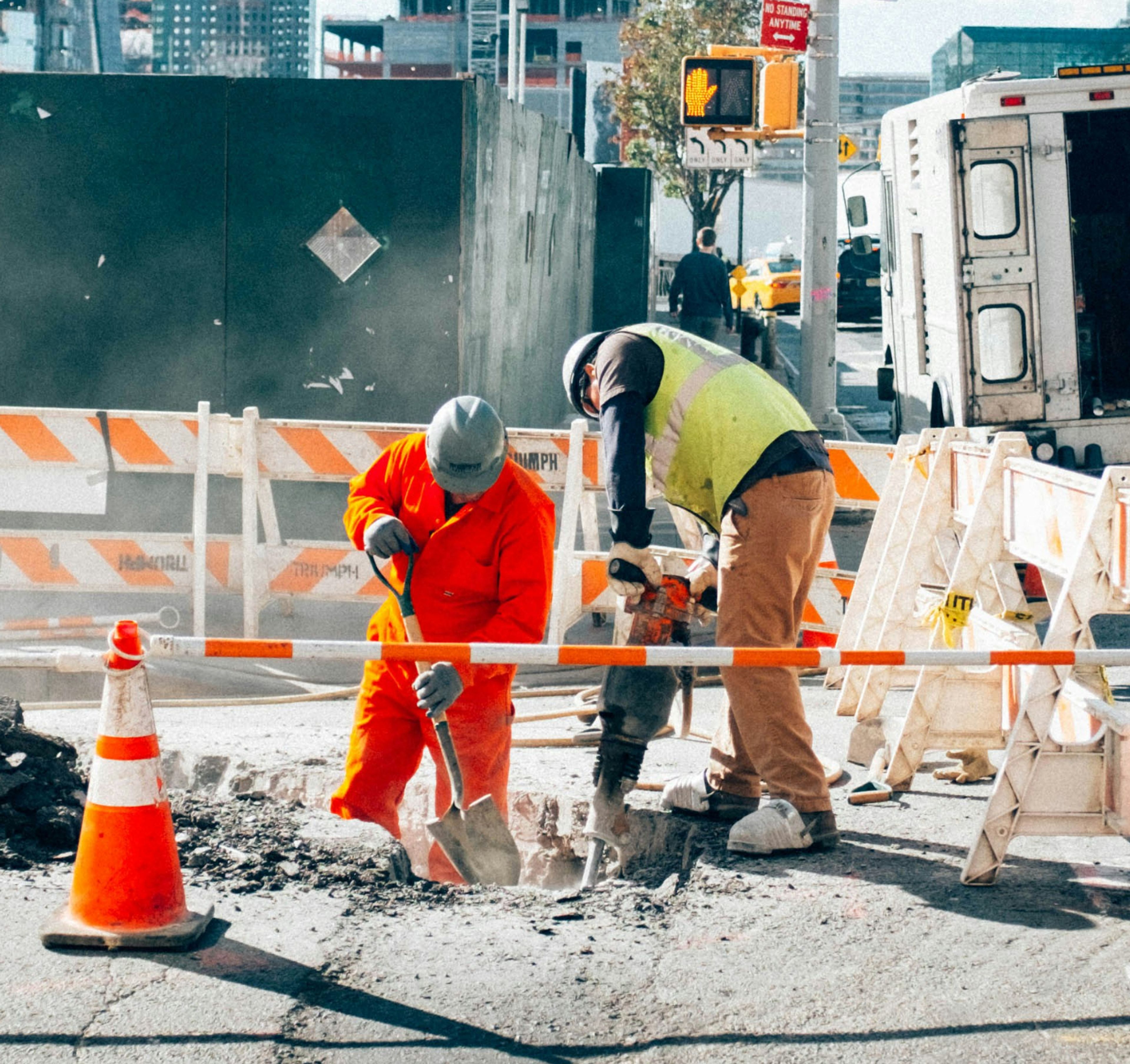 Construction workers digging a hole