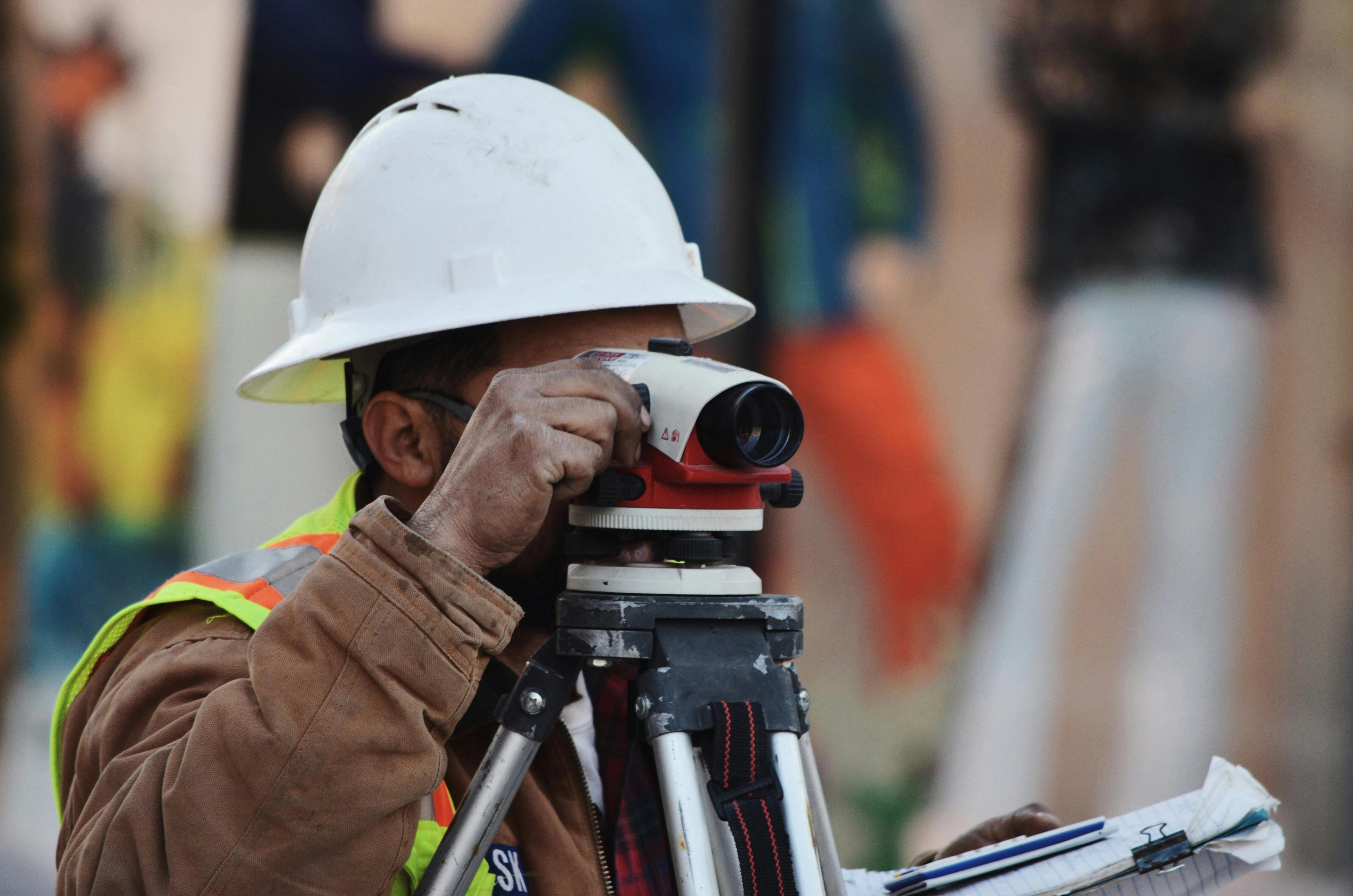 A construction worker surveying