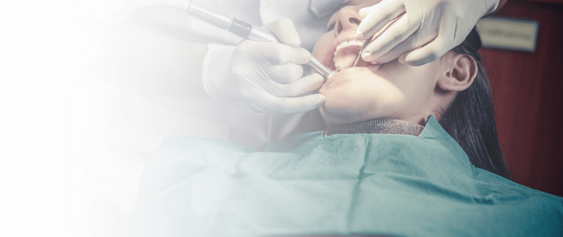Dentist examining a patient before wisdom tooth removal in Peshawar at DentoCorrect