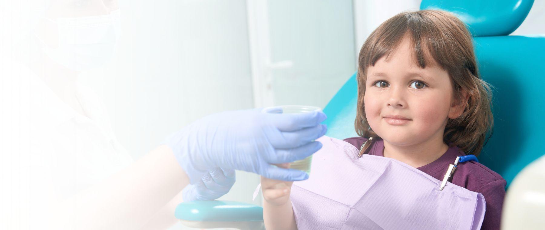 Kids dentist in Lahore examining a young child at DentoCorrect
