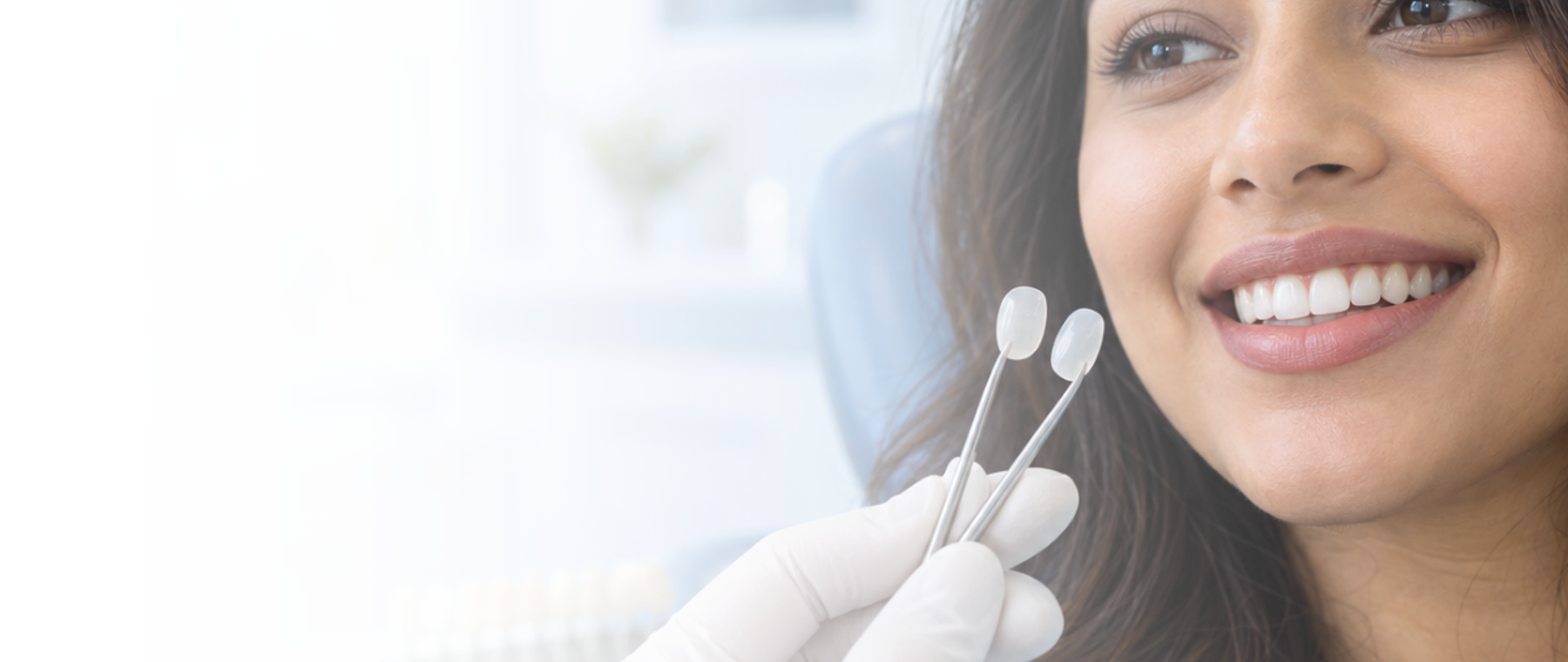 Dental veneers in Rawalpindi: dentist holding porcelain veneer shade samples beside a patient smile