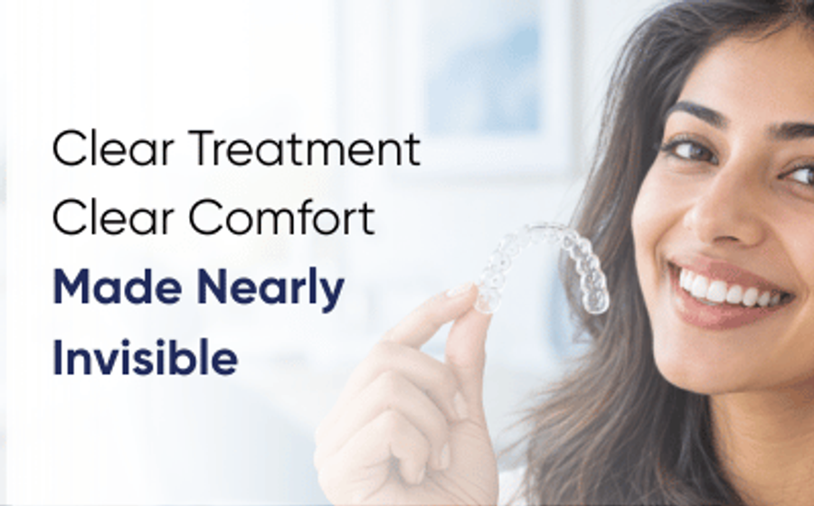 Clear aligners in Multan: patient holding a clear aligner tray beside her smile