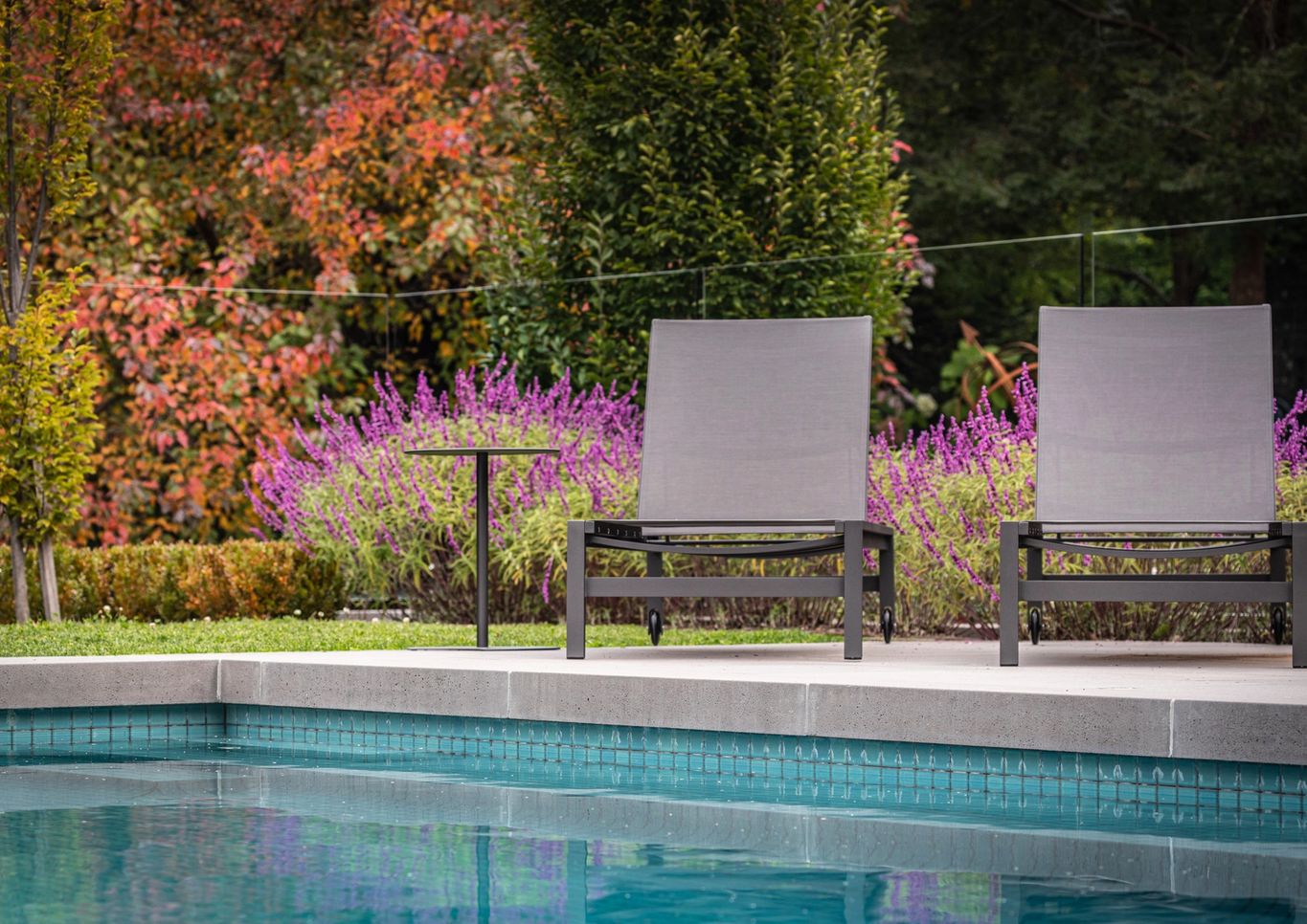 Pool and spa with sun loungers overlooking Macedon Ranges
