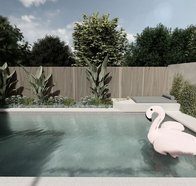 Pool view featuring flamingo pool float and lush tropical plants