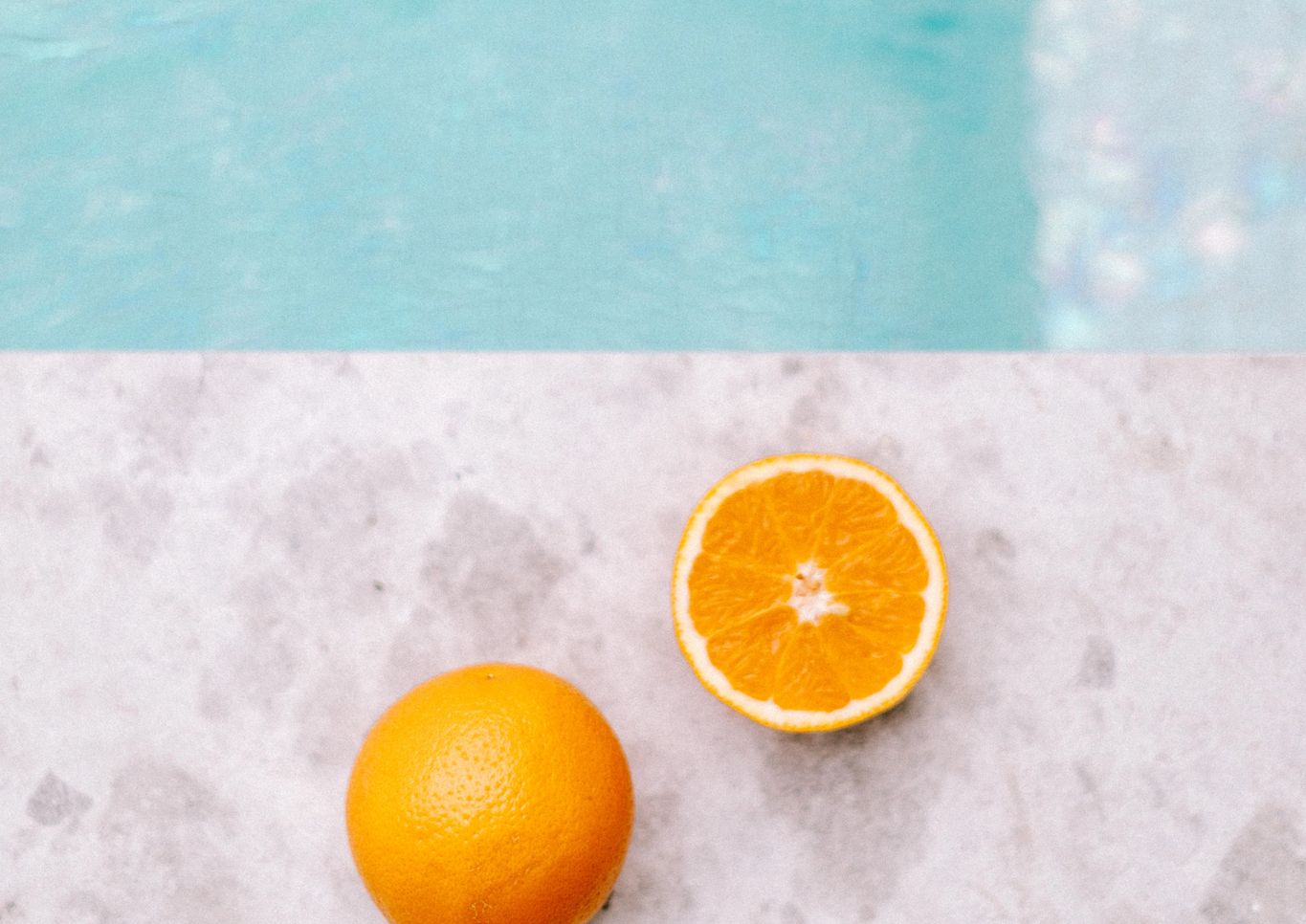 Pool paving with water and an orange in view