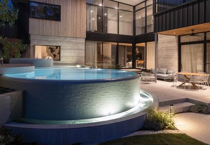 Curved modern infinity pool design by Mint Design