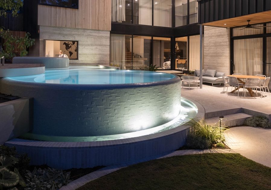Photo of curved infinity edge luxury pool by Mint Design