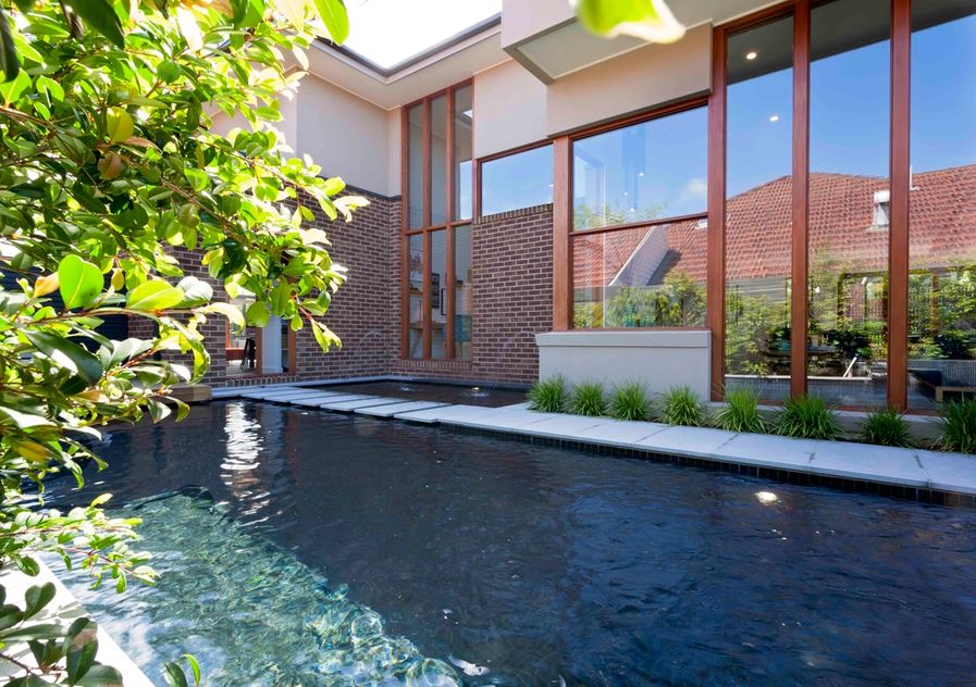 Dark pool through the trees towards house landscape design in Camberwell Melbourne