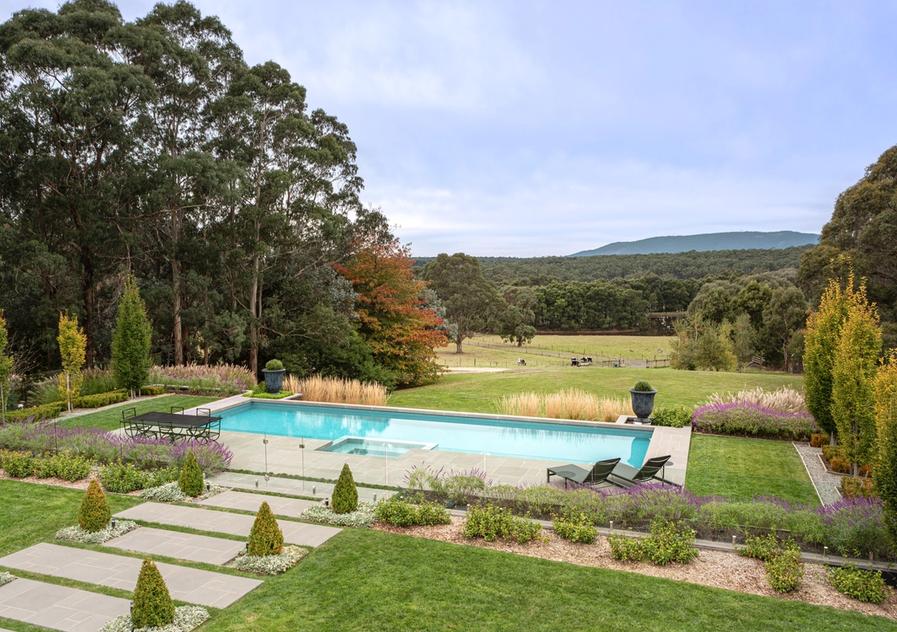 Pool and landscape of autumn trees overlooking the Macedon Ranges