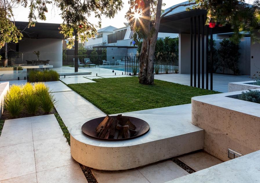Firepit with built in seating viewing across to the pool and dining areas of the outdoors