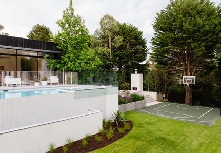 pool across to basketball court with outdoor fireplace in the background