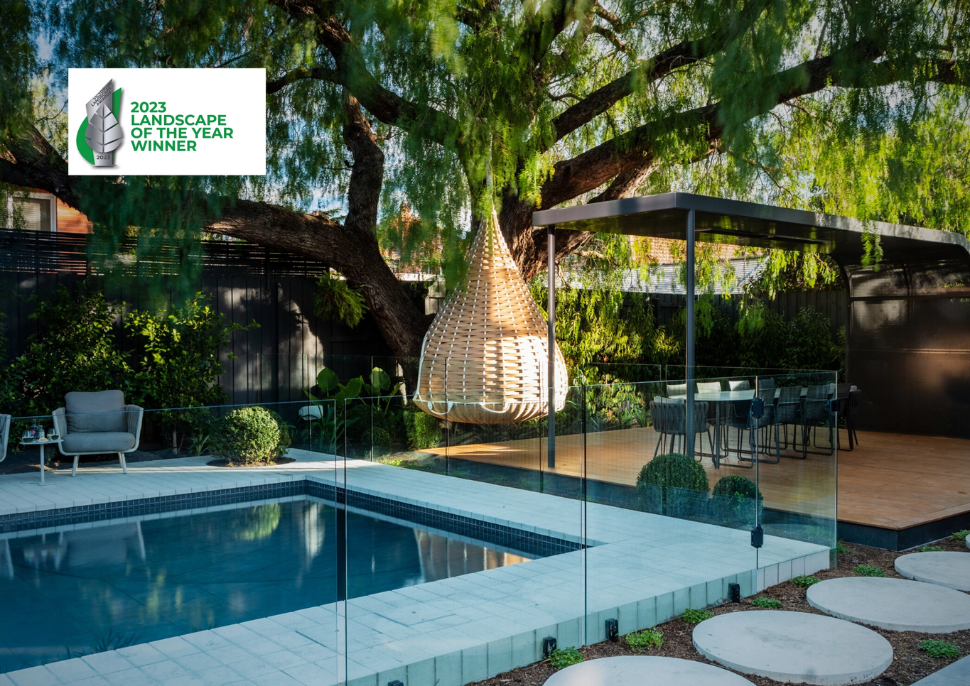 Award winning pool with raised spa and custom pergola and outdoor dining design