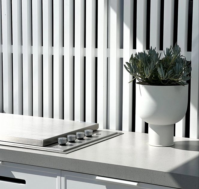 White outdoor kitchen built by OKD for Mint Landscape Design