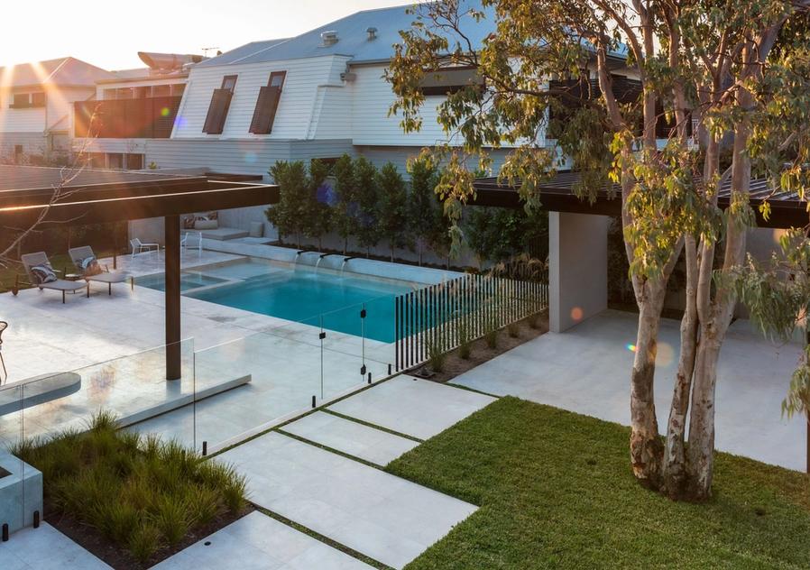 View of the pool, spa and outdoor pavilion from the balcony of this Williamstown beach house with landscape design by Mint