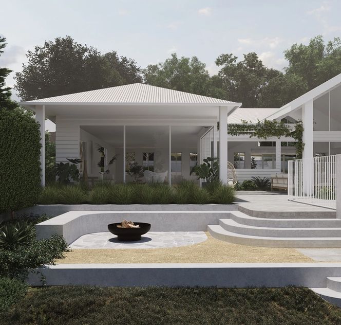 Modern firepit area with crazy paving and architectural concrete seating in front of a white country home