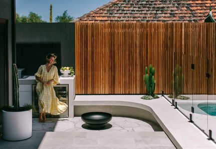 The backyard transformation of Sarita and Brodie Holland including curved pool and round spa
