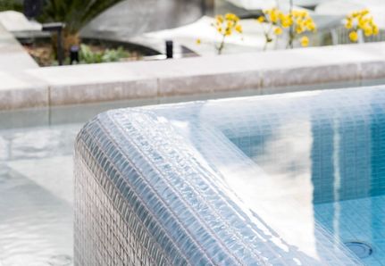 Luxury infinity edge Pool in pale blue tile 