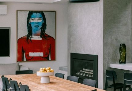 Inside the poolhouse kitchen and dining featuring David Bromley artwork.