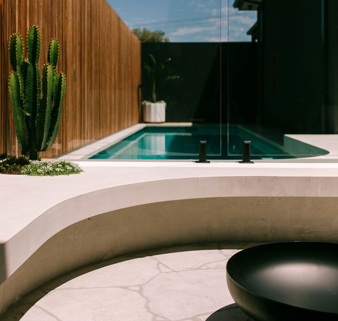 Firepite area near to pool with curved concrete bench seating