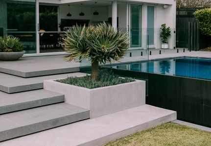Infinity edge rectangular pool shape in a dark grey black tile by Mint Design