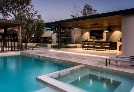 Looking at the pool and outdoor kitchen with Cosh Living outdoor furniture at Williamstown Beach House project by Mint Design