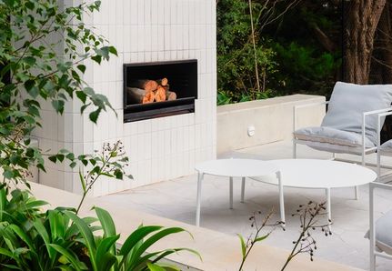White outdoor fireplace and seating