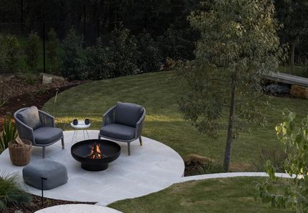 Backyard lounge area with firepit and round paving