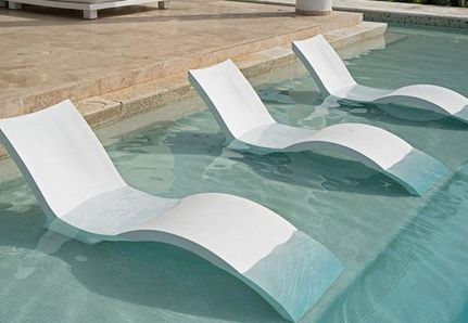 Lounge chairs built in to a pool