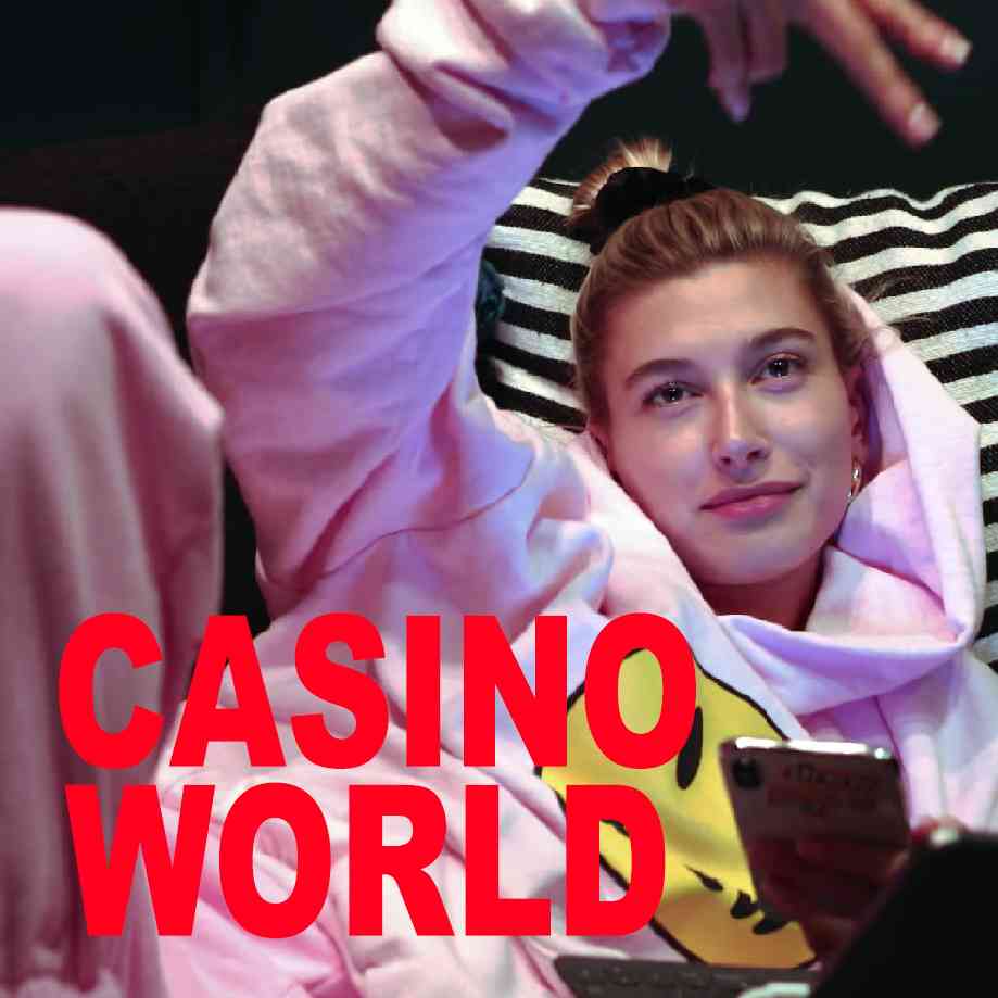 Podcast cover. Red Text: “CASINO WORLD.” Image: Hailey Bieber throws a gang sign while laying in bed looking at her phone.