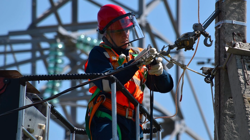 Utility worker maintaining power lines