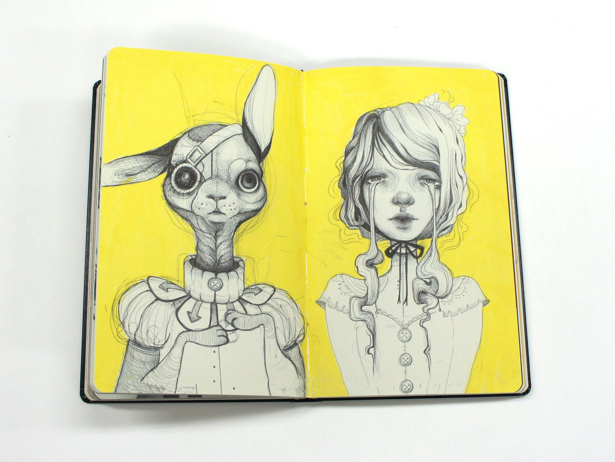 Open sketchbook with pencil portraits of a mechanical rabbit and a young woman on bright yellow pages.