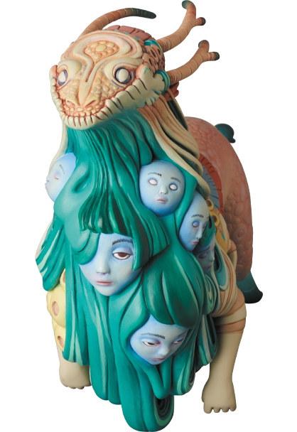 Surreal painted sculpture of a horned creature draped in teal hair embedded with pale human faces.