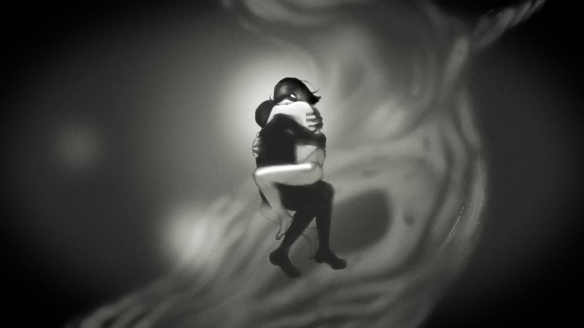 Black-and-white underwater photograph of two people embracing, one wrapped around the other's waist.