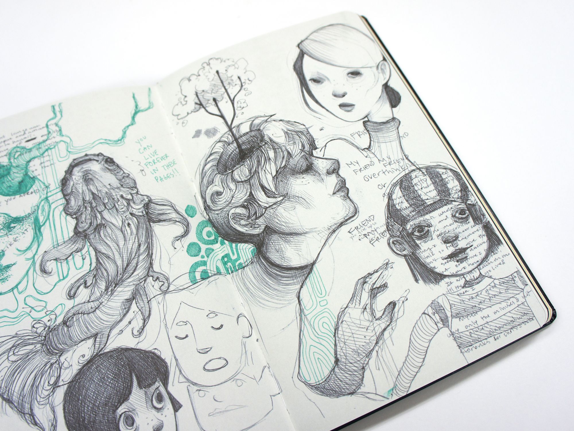 Open sketchbook filled with intricate black ink portraits, figures and teal abstract doodles.