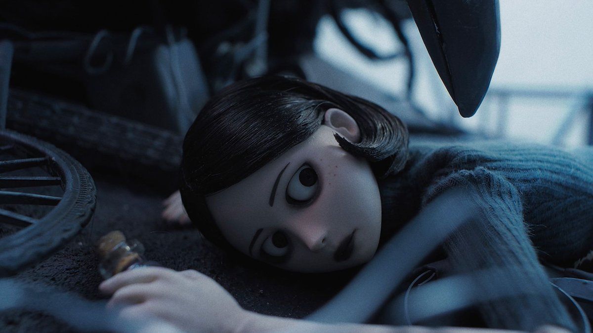 Animated pale girl with black hair lies beneath machinery, staring upward in a dim blue-lit scene.