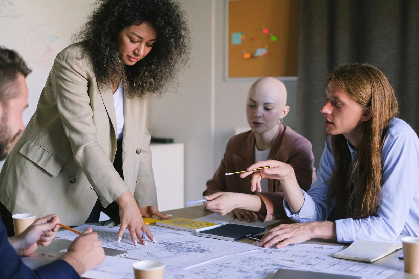 A project team working through plans around a table