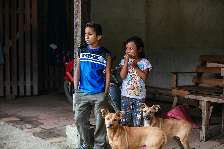 Two children and three dogs in a rural setting, possibly in Nicaragua.