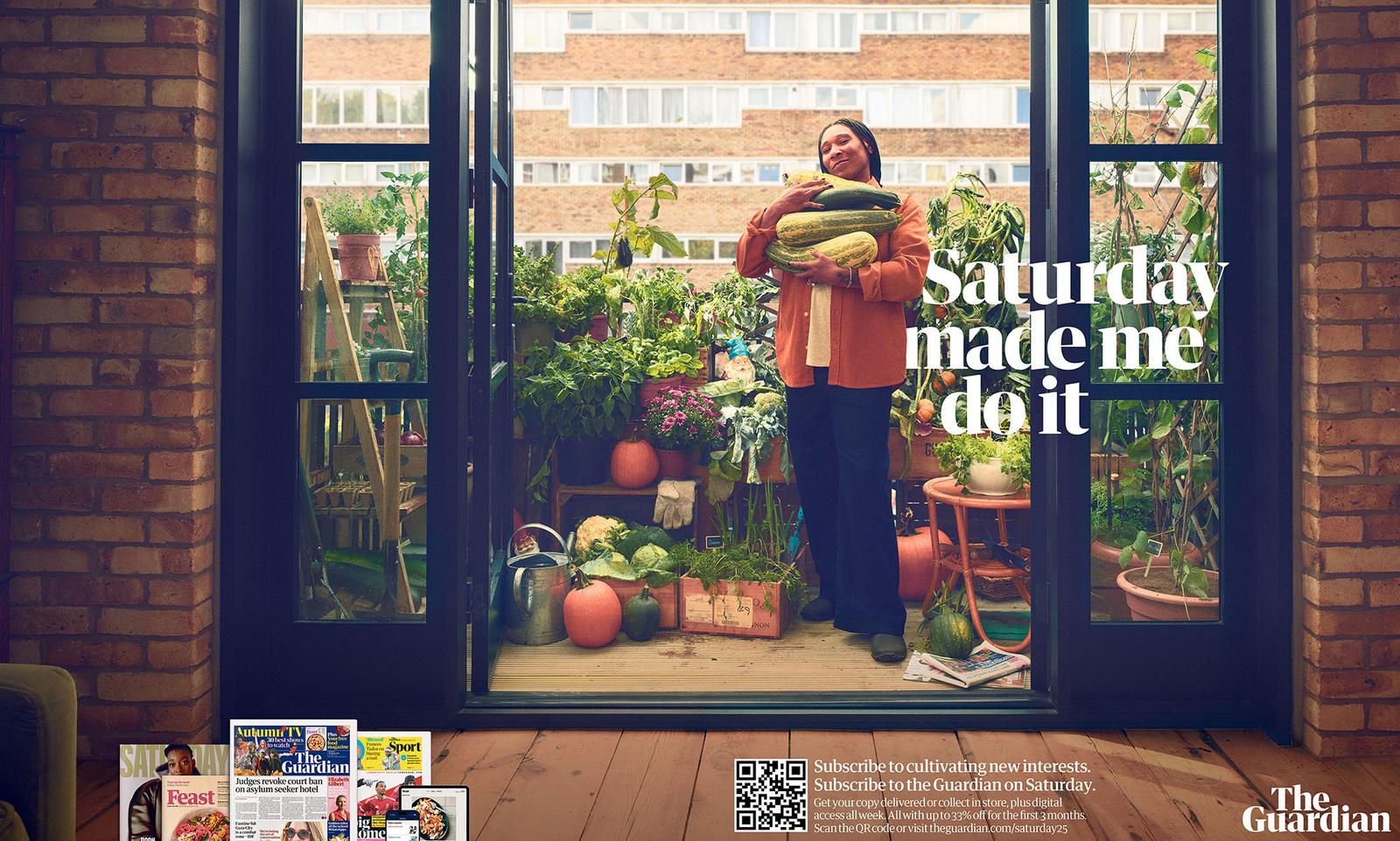A woman in a red jacket and black trousers stands in a garden, holding a large basket of fresh vegetables.