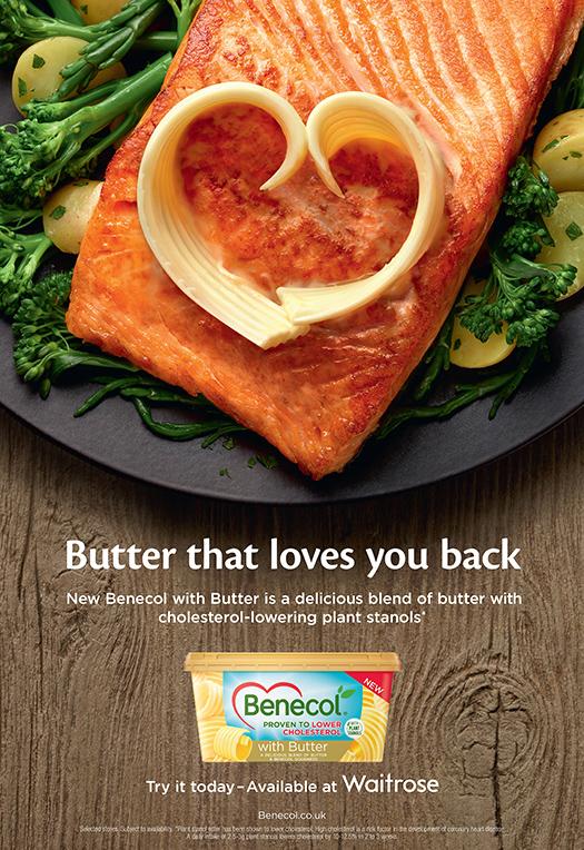 A plate of salmon with a heart-shaped butter on top, surrounded by vegetables and a Benecol Butter package in the background.