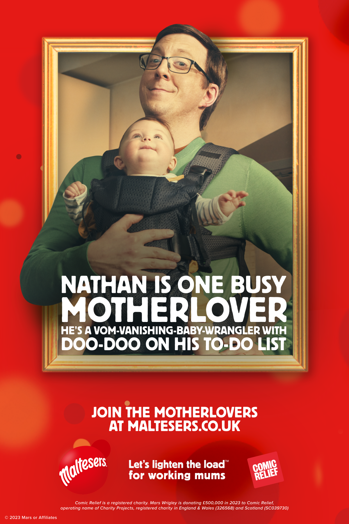 A man holds a baby in a carrier with a humorous expression.